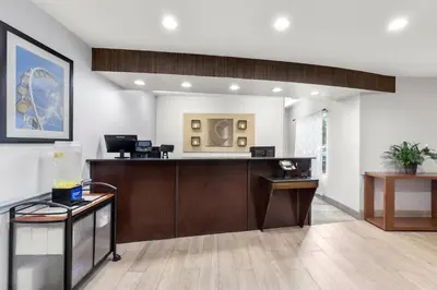 an office lobby with a reception desk and a counter at Comfort Suites Near Universal Orlando Resort in Orlando