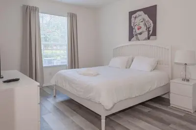 a white bedroom with a white bed and a window at 2785AL-SVH Brand New Apartment! in Orlando