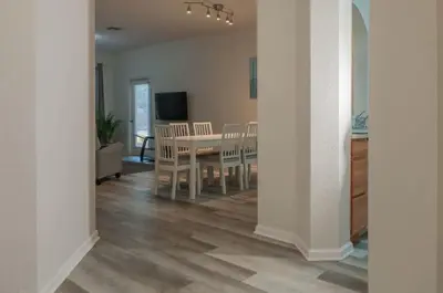 a kitchen and dining room with a table and chairs at 2785AL-SVH Brand New Apartment! in Orlando