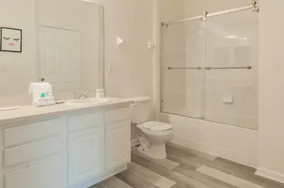 a white bathroom with a toilet and a shower at 2785AL-SVH Brand New Apartment! in Orlando