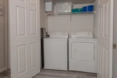 a kitchen with white appliances and a white door at 2785AL-SVH Brand New Apartment! in Orlando