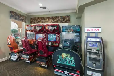 a room with a bunch of arcade games and consoles at 2785AL-SVH Brand New Apartment! in Orlando