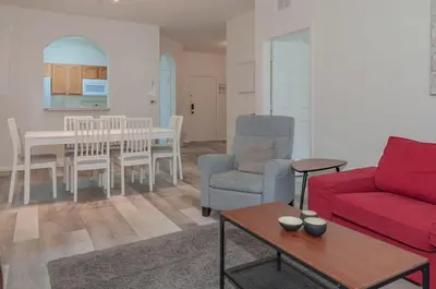 a living room with a red couch and a table at 2785AL-SVH Brand New Apartment! in Orlando