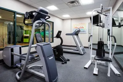a gym with treadmills and ellipticals in a room at Wingate By Wyndham - Orlando International Airport- Free Hot Breakfast in Orlando