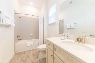 a white bathroom with a sink and a toilet at Sunrise Cottage Near Disney With Margaritaville Resort & Island H20 Waterpark Access - 2988Sr in Orlando