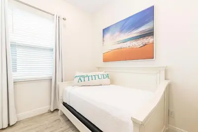 a white bedroom with a bed and a window at Sunrise Cottage Near Disney With Margaritaville Resort & Island H20 Waterpark Access - 2988Sr in Orlando