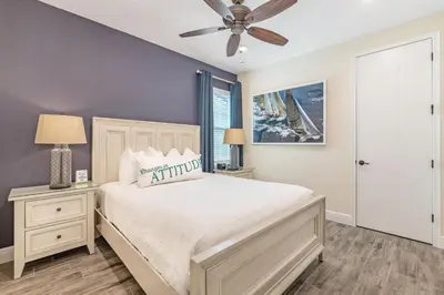 a bedroom with a bed and a ceiling fan at Setting Sail Cottage With Private Hot Tub Near Disney With Margaritaville Resort & Island H2O Access - 8057Dr in Orlando