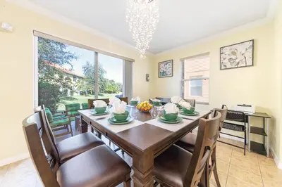 a dining room with a table and chairs at Lovely Disney Vacation House in Orlando