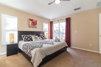 a bedroom with a large bed and a window at Terra Verde Resort!! Private Pool, Game Room, Near Disney And Universal!! in Kissimmee