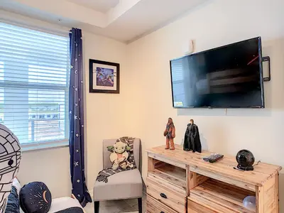 a living room with a large flat screen tv on the wall at Splendid Thematic 2BR with Waterpark in Kissimmee