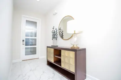 a mirror on a dresser in a white room at Gorgeous 5 Bd Single Family Close to Disney @ Storey Lake Resort 2734 in Kissimmee