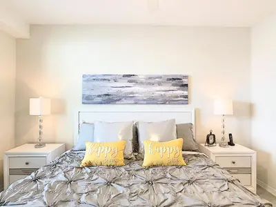 a bedroom with a bed with two night stands at Lakeview Themed 2BR Condo with Waterpark Access in Kissimmee
