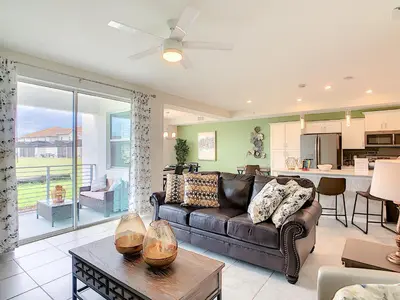 a living room with a couch and a table at Lakeview Themed 2BR Condo with Waterpark Access in Kissimmee