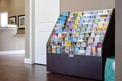 a display of books on a wall next to a door at Great townhouse in great luxurious community, poolgym Close to Disney! in Kissimmee