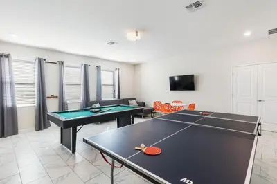 a living room with two ping pong tables in it at 2957 FS - Luxury Oasis: 6BR Villa Pool Game in Kissimmee