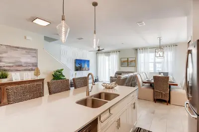 a kitchen with a sink and a living room at 4801 ML - Ideal Retreat Townhome Oasis with Pool in Kissimmee