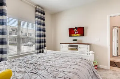 a white bedroom with a bed and a window at 4801 ML - Ideal Retreat Townhome Oasis with Pool in Kissimmee