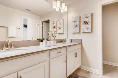 a white bathroom with a sink and a mirror at 4801 ML - Ideal Retreat Townhome Oasis with Pool in Kissimmee