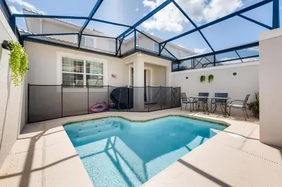 a swimming pool in a house with a glass ceiling at 4801 ML - Ideal Retreat Townhome Oasis with Pool in Kissimmee