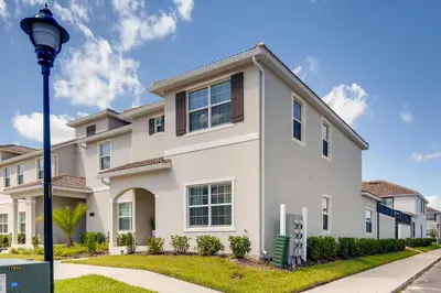 a white house with a street light at 4801 ML - Ideal Retreat Townhome Oasis with Pool in Kissimmee