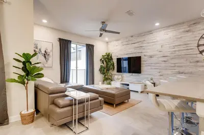 a living room with a stone wall at 4808 LL Magical 4BR Disney Townhome Pool in Kissimmee