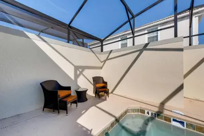 a balcony with two chairs and a swimming pool at 4825 LL - Storey Lake in Kissimmee