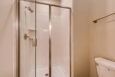 a shower stall in a bathroom with a toilet at 4825 LL - Storey Lake in Kissimmee