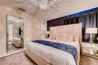 a bedroom with a large bed and a mirror at 4825 LL - Storey Lake in Kissimmee