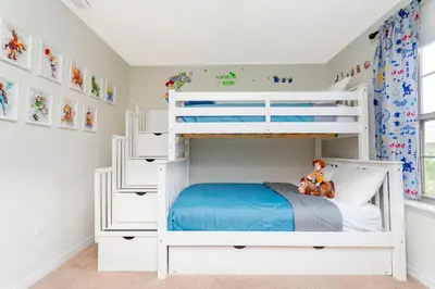 a white bunk bed in a childs bedroom at 8843 GC Windsor at Westside Luxury 5 BR Townhome in Kissimmee