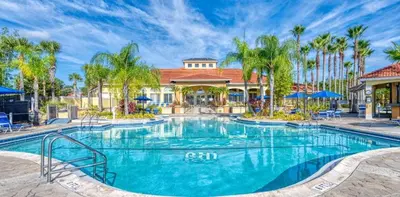 a swimming pool at a resort with palm trees at 139PBD-SVH Lovely New Townhome! in Kissimmee
