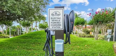 a sign for a bicycle parking charging station at 139PBD-SVH Lovely New Townhome! in Kissimmee