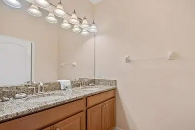 a bathroom with a sink and a large mirror at 2947BPD-SVH in Kissimmee