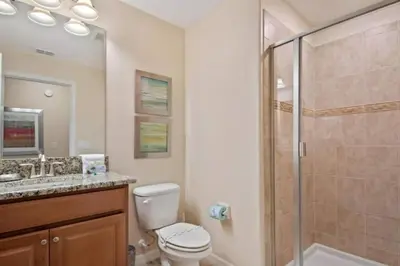 a bathroom with a shower and a toilet and a sink at 2947BPD-SVH in Kissimmee
