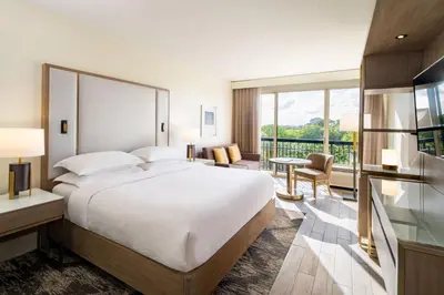 a hotel room with a bed and a balcony at Sheraton Orlando North in Orlando