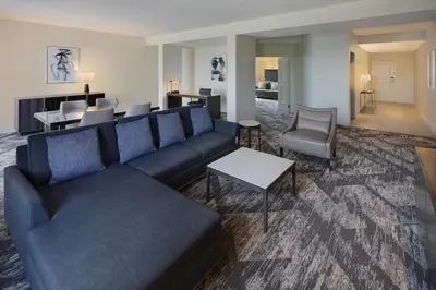 a living room with a blue couch and a table at Sheraton Orlando North in Orlando