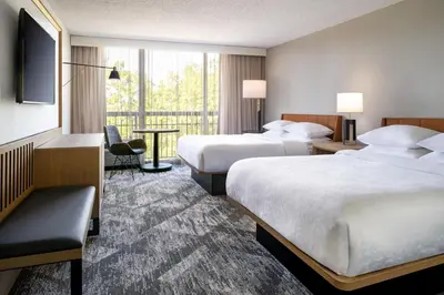 a hotel room with two beds and a balcony at Sheraton Orlando North in Orlando