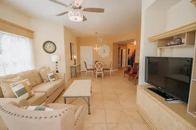 a living room with a couch and a flat screen tv at WorldQuest Orlando Resort in Orlando