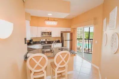 a kitchen with two chairs and a counter top at WorldQuest Orlando Resort in Orlando