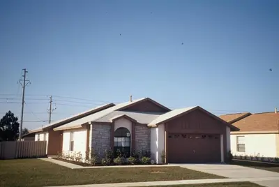 a house with a garage in a residential neighborhood at Laguna Villas in Kissimmee