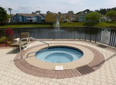 a circular pool with a chair in a yard at Disney Holiday Home, Orlando in Kissimmee