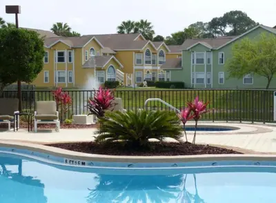 a pool in front of a building with condos at Disney Holiday Home, Orlando in Kissimmee