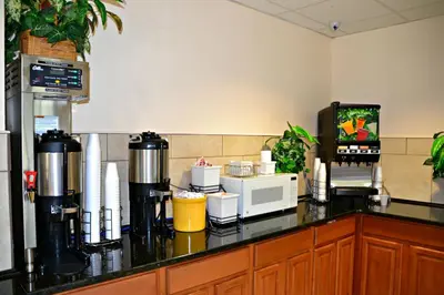 a kitchen with a counter top with a microwave at Baymont by Wyndham Orlando-International Dr-Universal Blvd in Orlando