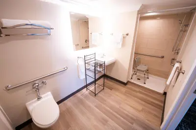 a bathroom with a toilet and a sink and a shower at Mai Hana Hotel and Suites I Drive-Theme Parks in Orlando