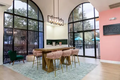 a dining room with a table and chairs and windows at Legacy Vacation Resorts - Disney and Lake Buena Vista in Orlando