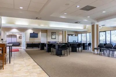 a large room with black chairs and tables and windows at Legacy Vacation Resorts Kissimmee & Orlando - Near Disney in Kissimmee