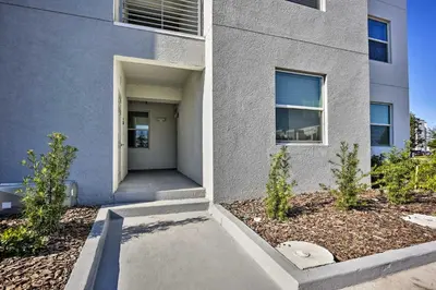 a building with a walkway in front of a building at Kissimmee Condo with Resort-Style Amenities! in Kissimmee