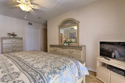 a bedroom with a bed and a mirror and a television at Close to Disney and Resort Perks Kissimmee Condo in Kissimmee