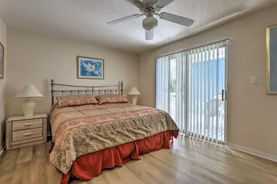 a bedroom with a bed and a large window at Close to Disney and Resort Perks Kissimmee Condo in Kissimmee