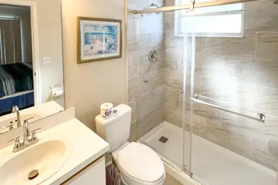 a bathroom with a shower and a toilet and a sink at Close to Disney and Resort Perks Kissimmee Condo in Kissimmee