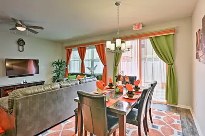 a living room with a table and a couch at Theme Park Retreat with 5-Star Amenities - By Disney in Kissimmee